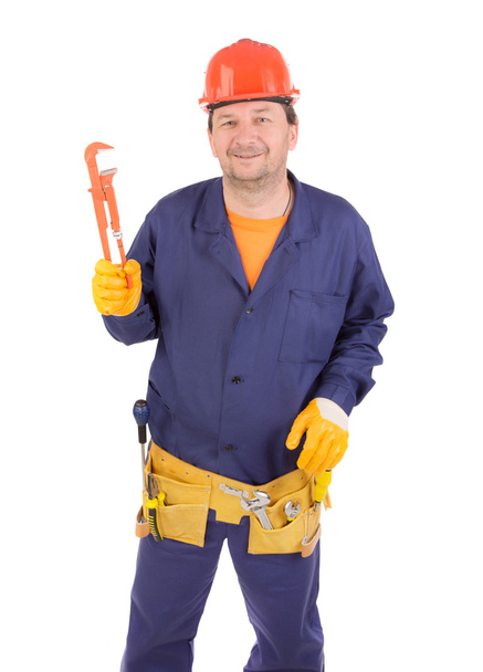 Worker in hard hat holding wrench. - Zdjęcie, obraz
