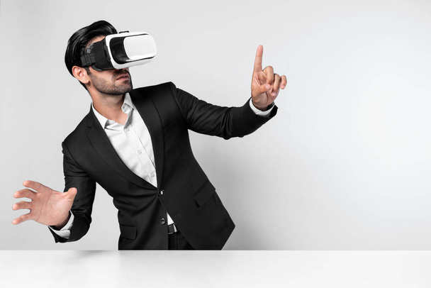 Smart businessman standing at table with laptop while choosing data analysis by using technology innovation. Skilled caucasian project manager using virtual reality glasses and VR goggles. Deviation. - Photo, Image