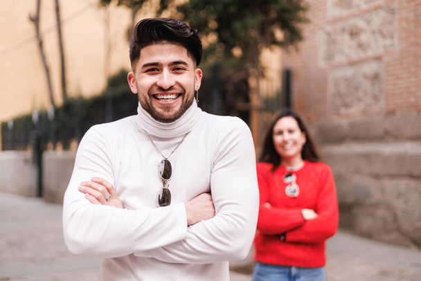 Portrait of a man in a white turtleneck sweater is standing next to a woman in a red sweater. High quality photo - Photo, Image