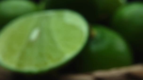 Macrography, slices of lime are showcased with a black background, creating a striking visual contrast. Each close-up shot captures the texture and vivid green color of the lime slices. Comestible. - Footage, Video