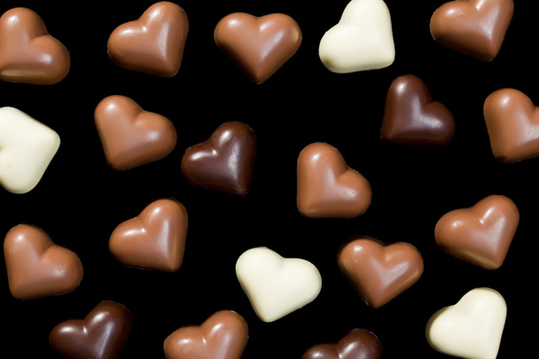 Chocolate hearts on black - Foto, Imagen