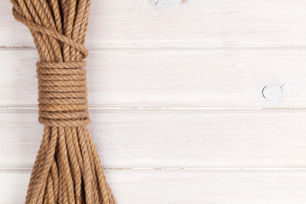 Wooden background with marine rope - Foto, afbeelding