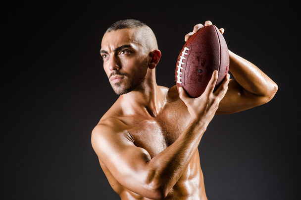 Muscular football player with ball - Foto, Imagen
