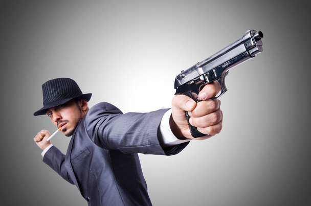 Businessman with gun against the gradient - Фото, зображення