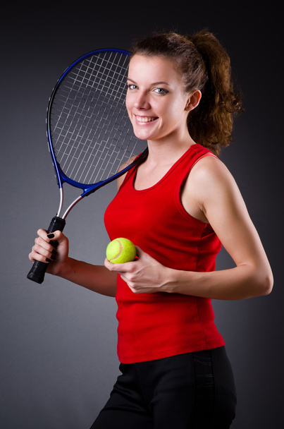 Woman tennis player against dark background - Foto, Imagem