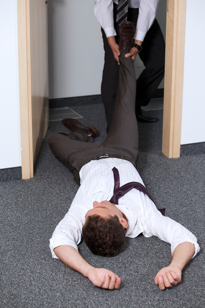 Businessmen pulling colleague's leg - Photo, Image