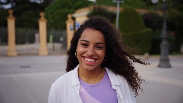 Beautiful happy African American girl. Portrait of cheerful young Latina woman standing outdoors and smiling at camera. Positive emotion concept of female person. Generation z looking camera carefree - Footage, Video