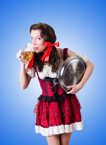 Bavarian girl with tray  against the gradient - 写真・画像