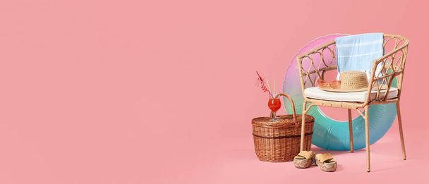 Wicker chair, basket, beach accessories and cocktail on pink background with space for text - Photo, Image