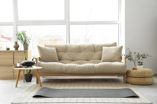 Interior of living room with sofa, yoga mat and glucophone - Φωτογραφία, εικόνα