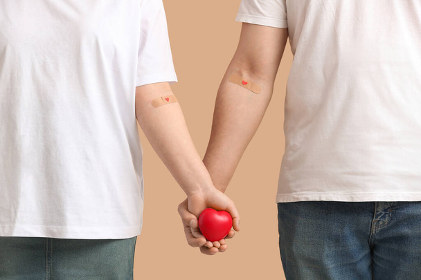 Blood donors with heart on beige background - Foto, Imagem