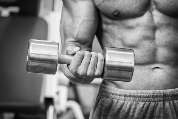 Man in a gym with dumbbells - 写真・画像