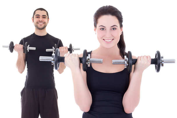 young attractive woman and man doing exercises with dumbbells is - Foto, Imagem