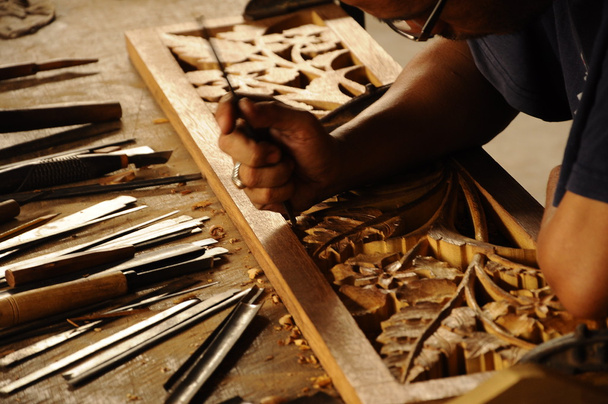 Skilled craftsman doing wood carving using traditional method - Photo, Image