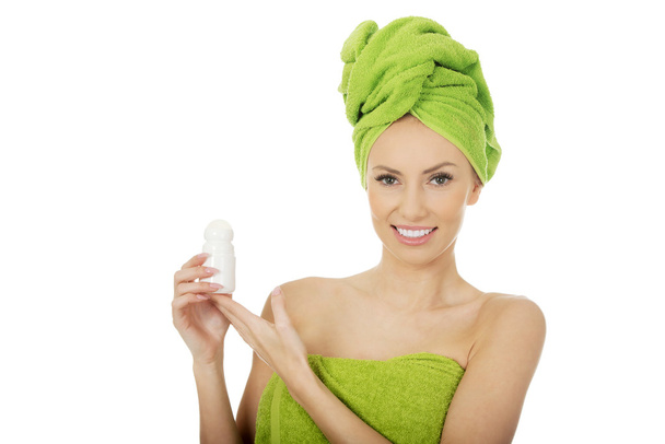 Woman holding deodorant. - Zdjęcie, obraz