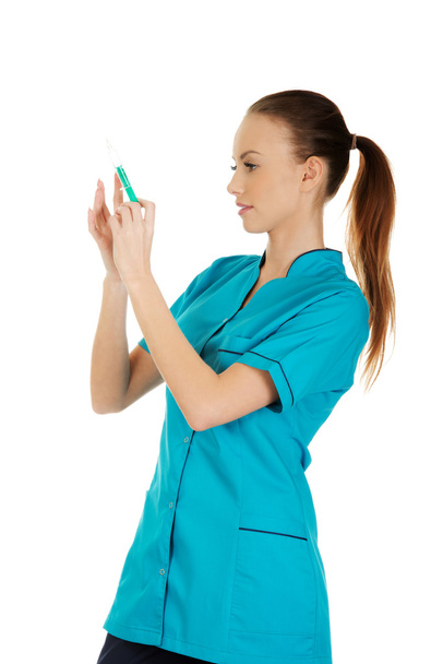 Nurse holdings a syringe in hands. - Fotoğraf, Görsel