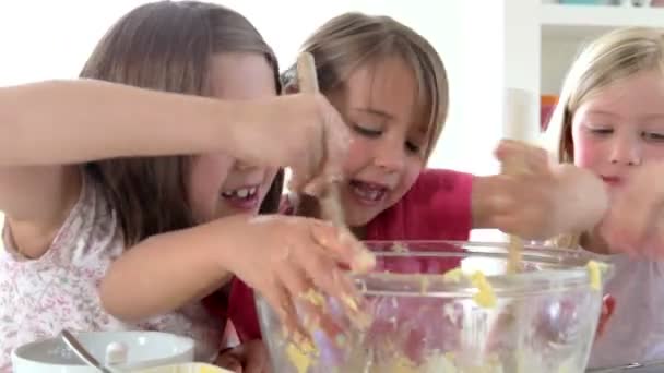 Three Little Girls Making Cake Together - Materiał filmowy, wideo