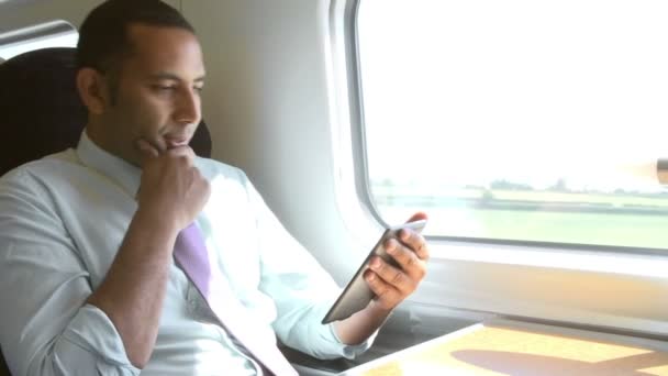 Businessman Reading e-reader in train - Кадри, відео