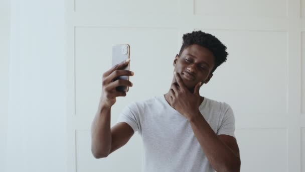 ocio. Hombre africano guapo haciendo selfie, admirándose en el teléfono celular - Imágenes, Vídeo