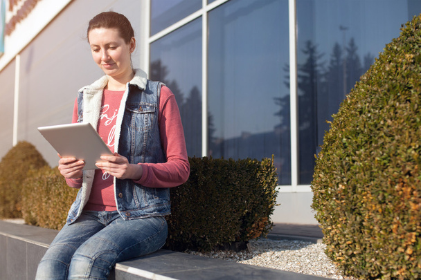 Woman using tablet pc outdoors - Photo, Image