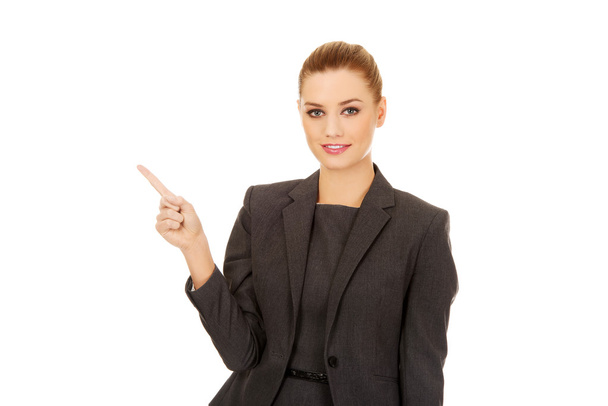 Young businesswoman pointing up. - Photo, Image