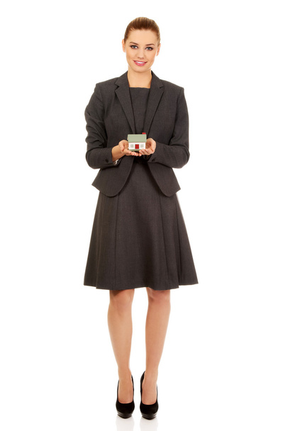 Businesswoman with house model. - Photo, Image