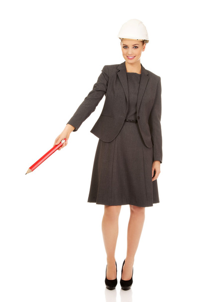 Businesswoman pointing up with pencil. - Zdjęcie, obraz