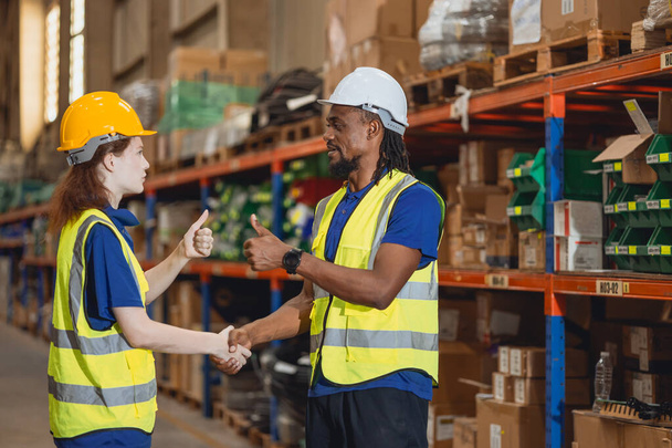Worker in cargo warehouse teamwork support trainee young women with African foreman help together - Φωτογραφία, εικόνα