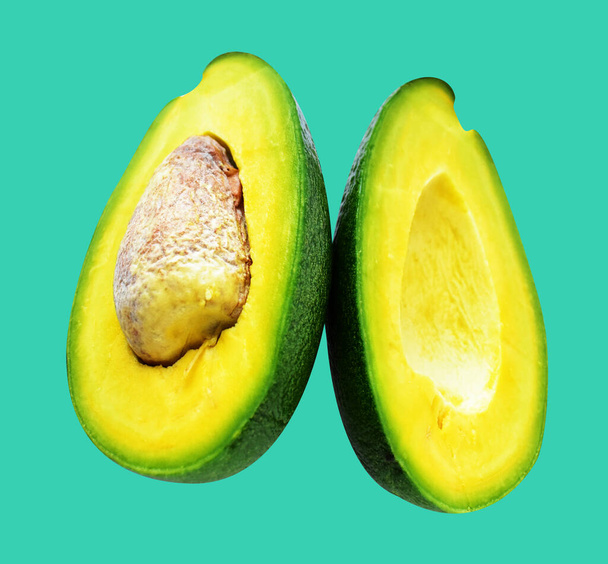 Avocado slice isolated with clipping path, no shadow in green background - Photo, Image