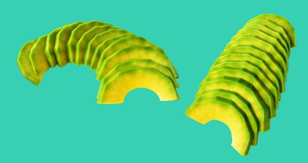 Avocado slice isolated with clipping path, no shadow in green background - Photo, Image