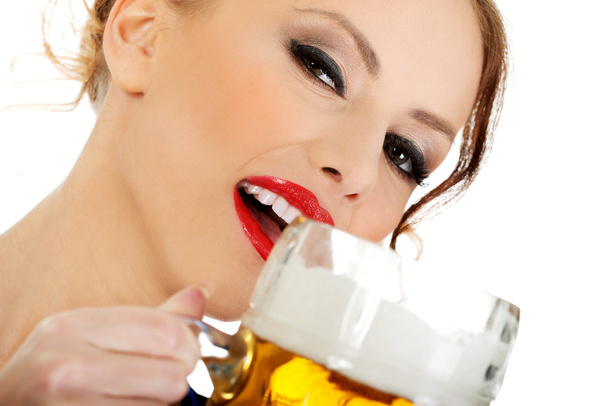 Bavarian woman drinking beer. - 写真・画像