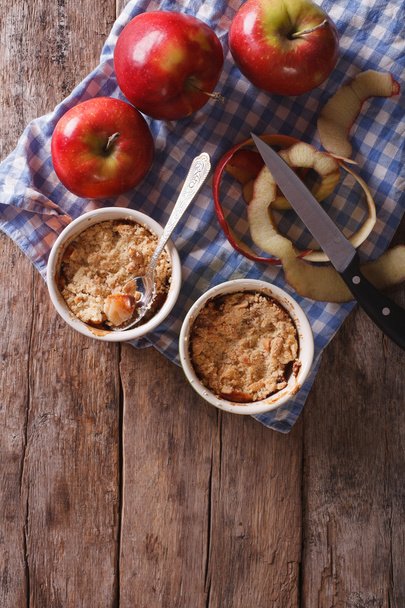 apple crumble in portion pots on the table. vertical top view - Photo, Image