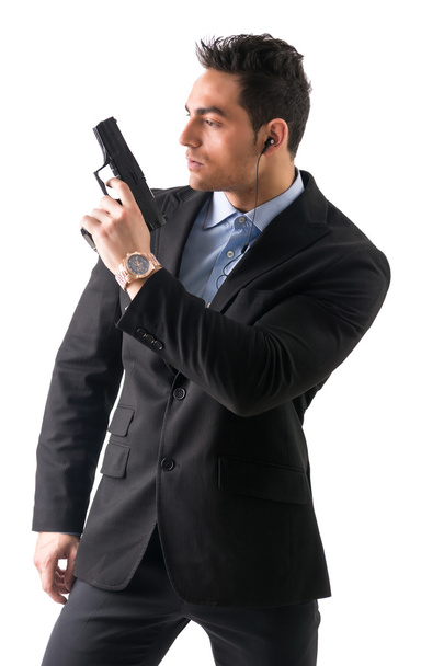 Elegant man with gun, dressed as a spy or secret agent - Photo, image