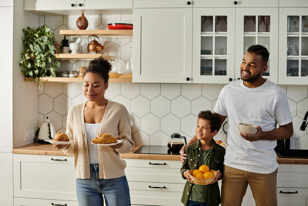 Αγαπώντας Αφρο-αμερικανική οικογένεια ετοιμάζει το φαγητό στην κουζίνα μαζί. - Φωτογραφία, εικόνα