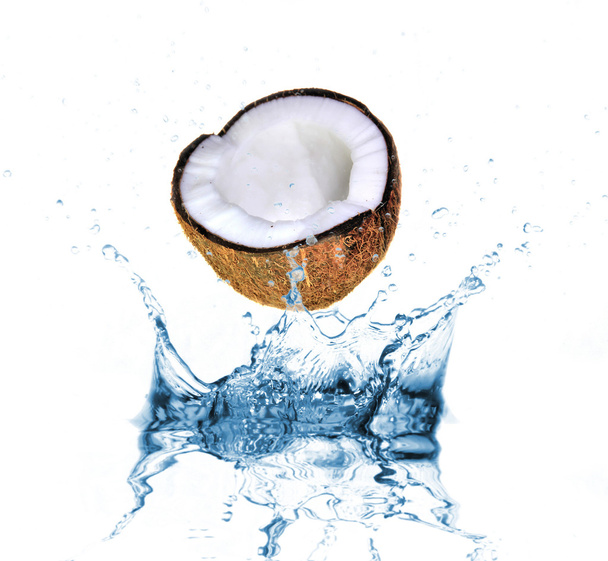 Coconut dropped into water splash on white - Foto, afbeelding