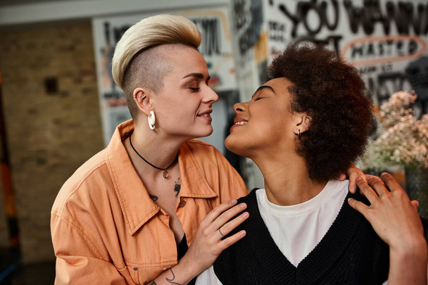 Two beautiful diverse lesbians standing together in a cafe. - Photo, Image