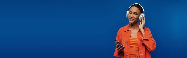 Афроамериканец, погруженный в разговор, держит мобильный телефон у своего лица. - Фото, изображение