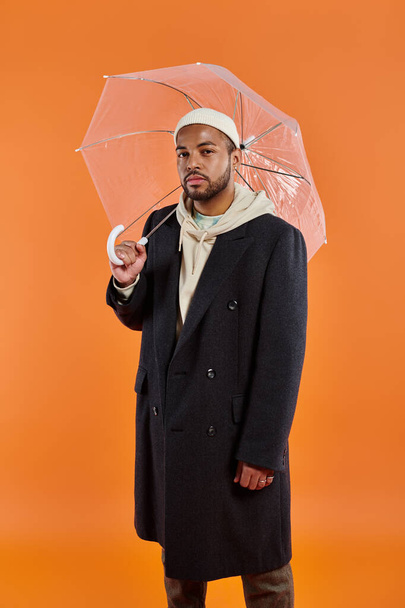 Stylish African American man in coat with umbrella. - Foto, Imagem