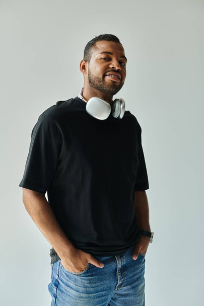 Stylish African American man enjoys music with headphones on. - Photo, Image