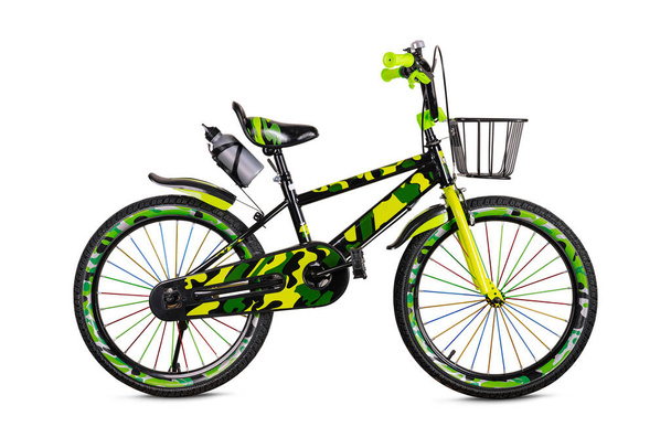 Vibrant kids bike with green and black pattern, equipped with training wheels and a basket - Zdjęcie, obraz