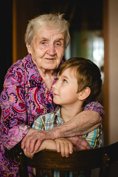 Heartwarming bond between a grandmother and her grandson as they create lasting memories in their home. - Photo, image