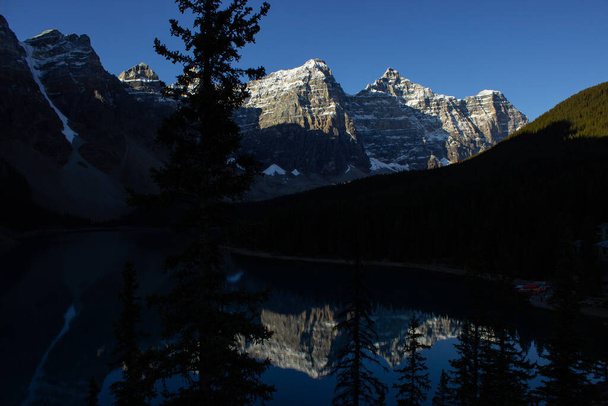 Valley of Ten Peaks near Moraine Lake on a sunny autumn day with snow on the mountain. Nice reflection of the mountains on a sunny morning. - Photo, Image
