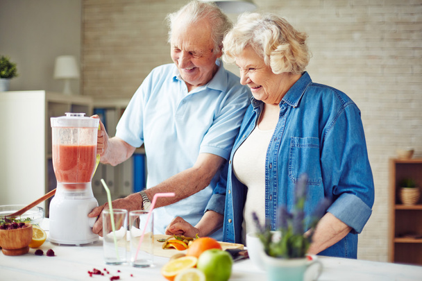 Vanhempi pari tekee hedelmiä smoothie
 - Valokuva, kuva