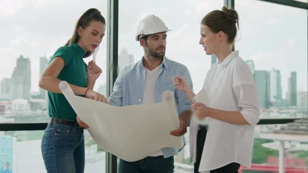 Professional architect engineer team talking, sharing, brainstorming about design while manager hold at project plan. Young architect holding plan while manager listen and point at plan. Tracery - Footage, Video