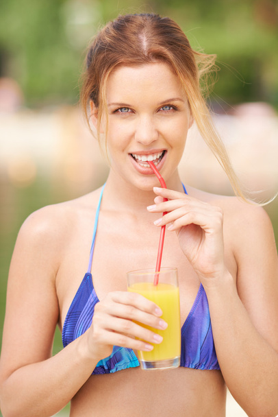 Woman in bikini drinking orange juice - Photo, Image