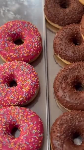 Brightly colored donuts on the counter. High quality FullHD footage - Footage, Video