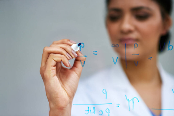 Hand, science and writing on glass with woman in studio on gray background for equation or formula. Innovation, problem solving and research with female scientist in laboratory for breakthrough. - Photo, Image