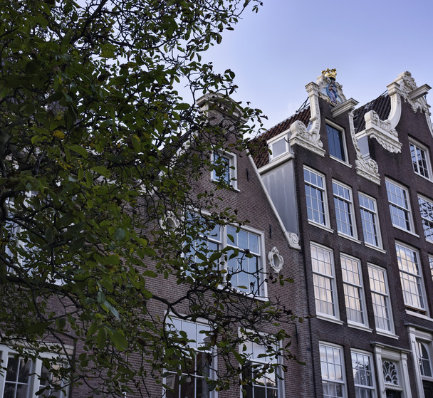 Holland, Amsterdam, the facade of old private stone houses - Φωτογραφία, εικόνα