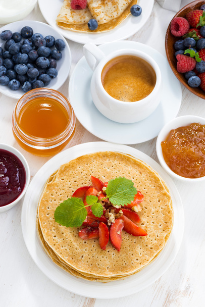 Crepes with strawberry, jams and honey on white background - Zdjęcie, obraz