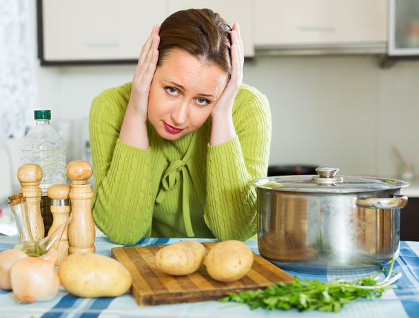 unhappy woman cookinng at home - Foto, imagen